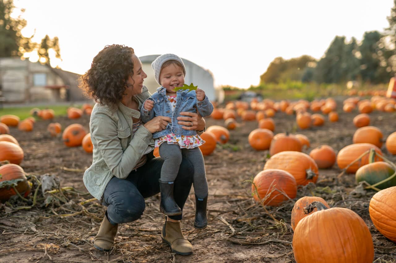 Cute family enjoying a pleasant day at the pumpkin patch without suffering from allergy symptoms.