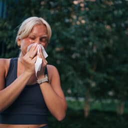 Woman with allergies sneezing
