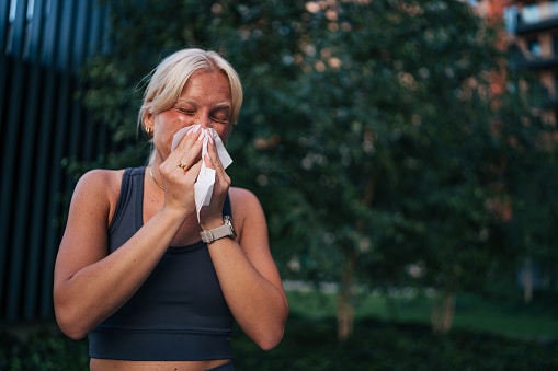 Woman with allergies sneezing