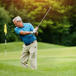 r man, golf stroke and sports with wellness, retirement and playing with grass field. Active, pensioner and mature guy with club, active and hobby with weekend break, motion and skills for game